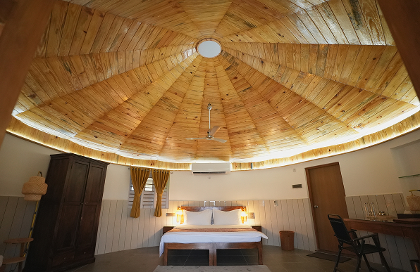 The 484 sqft The Bhonga is a dome- shaped retreat inspired by traditional rural architecture. With its natural materials, warm wooden ceiling, and minimal interiors, it offers a serene space for rest, reflection, and inner balance.