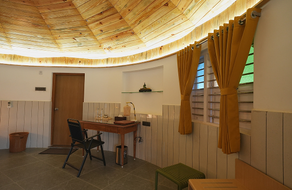 The Bhonga study area offers a quiet wooden desk space, designed for reading, reflection, and mindful work in a serene setting.